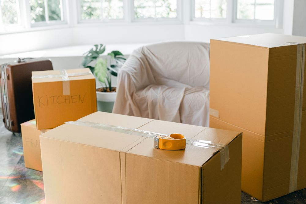 Cardboard moving boxes in a bright living room